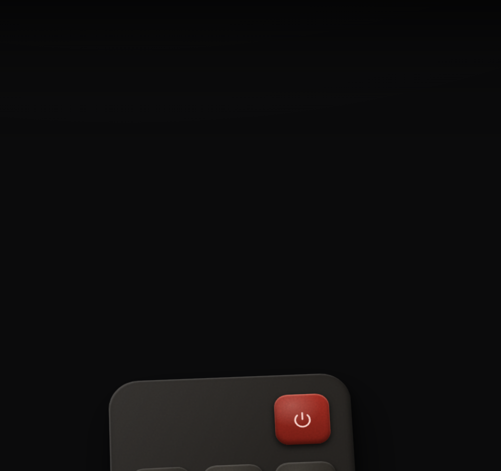 The remote at rest, tucked at the bottom edge with only the power button showing